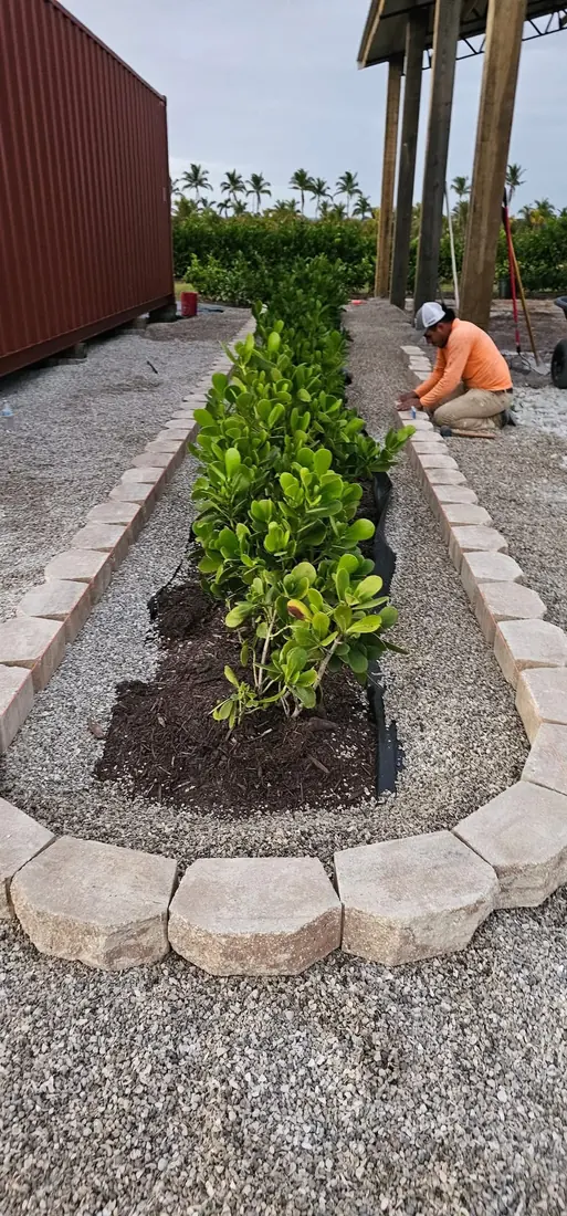 Custom stone bed edging installation by RDZ Home Services